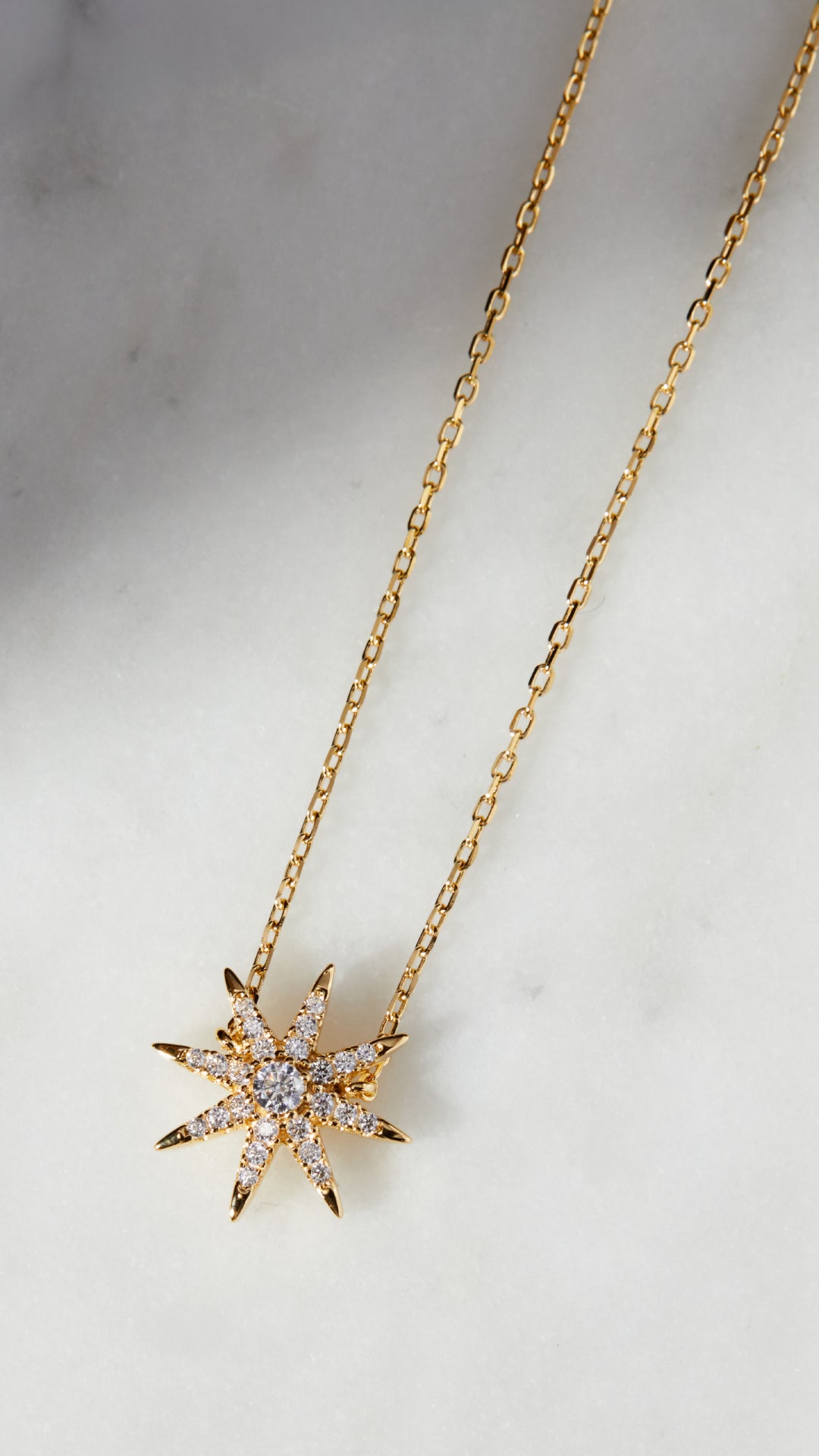 Gold chain star design necklace for women.