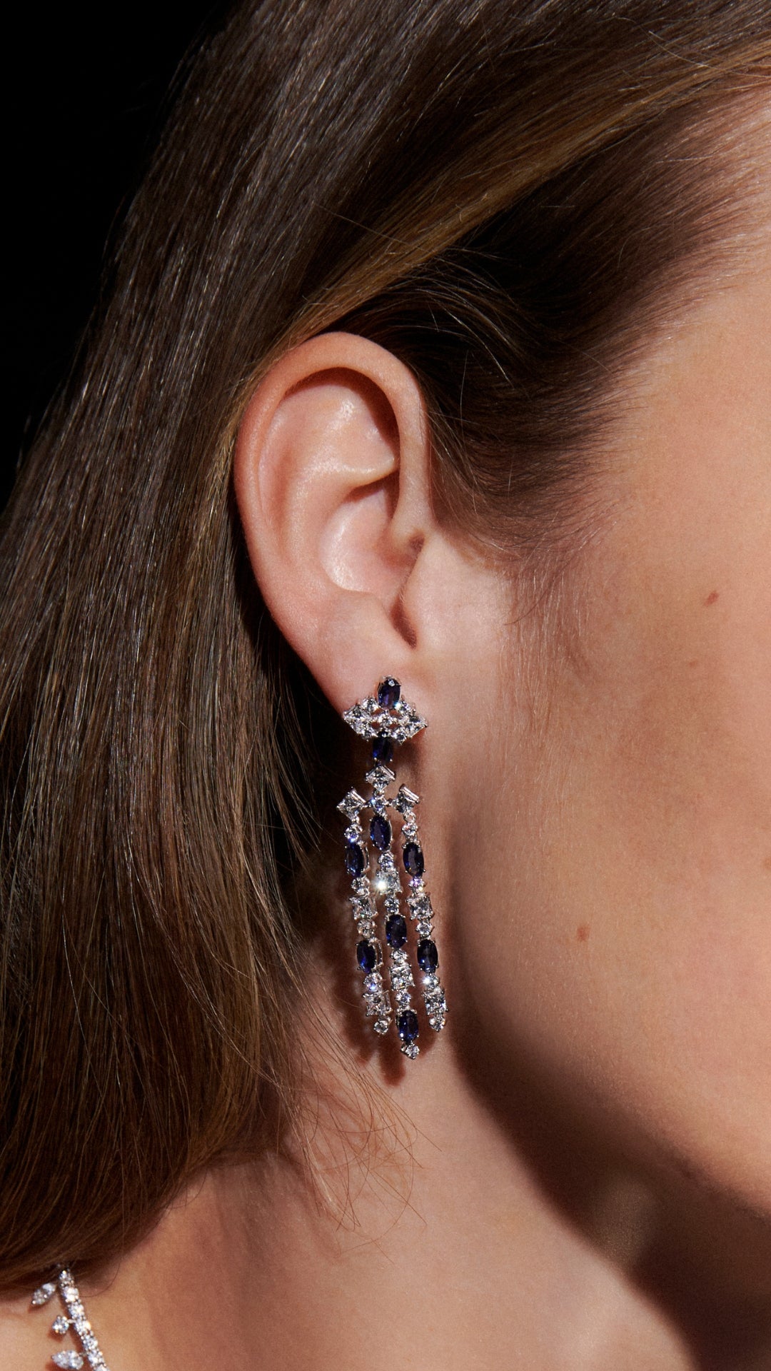 Brady chandelier sapphire drop earrings featuring a gentle cascade of princess, round, and oval-cut stones.