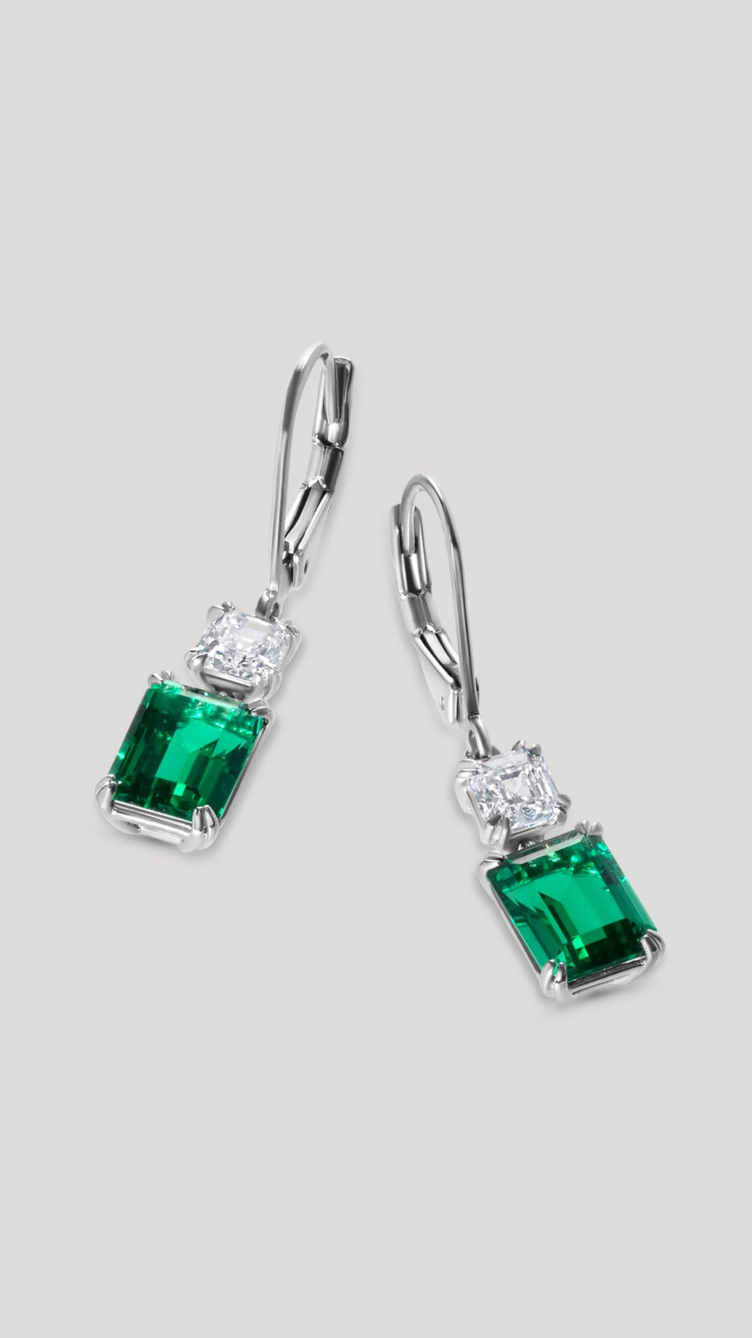 Classic earrings for women featuring a 1.5-carat equivalent Emerald cut stone in emerald green keystone.