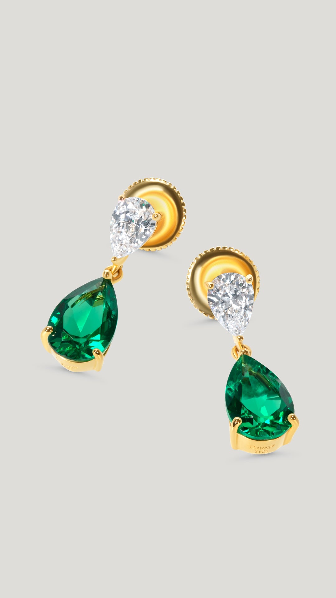 Delicate drop earrings for women with two pear cut studs in 0.75ct and 2.5ct white and emerald green.