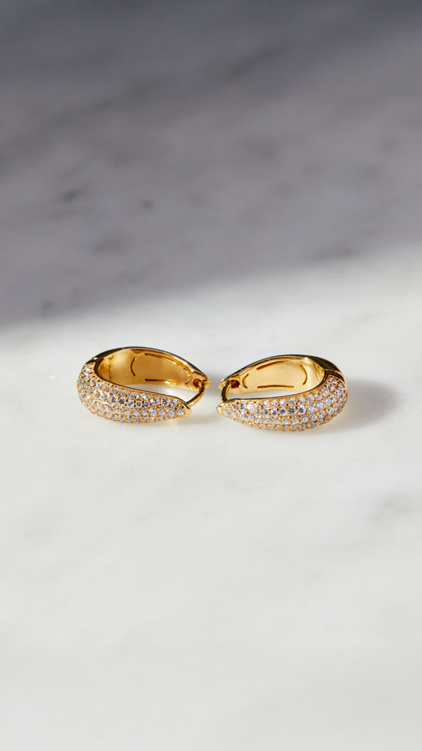 Gold teardrop pave hoop earrings for women.