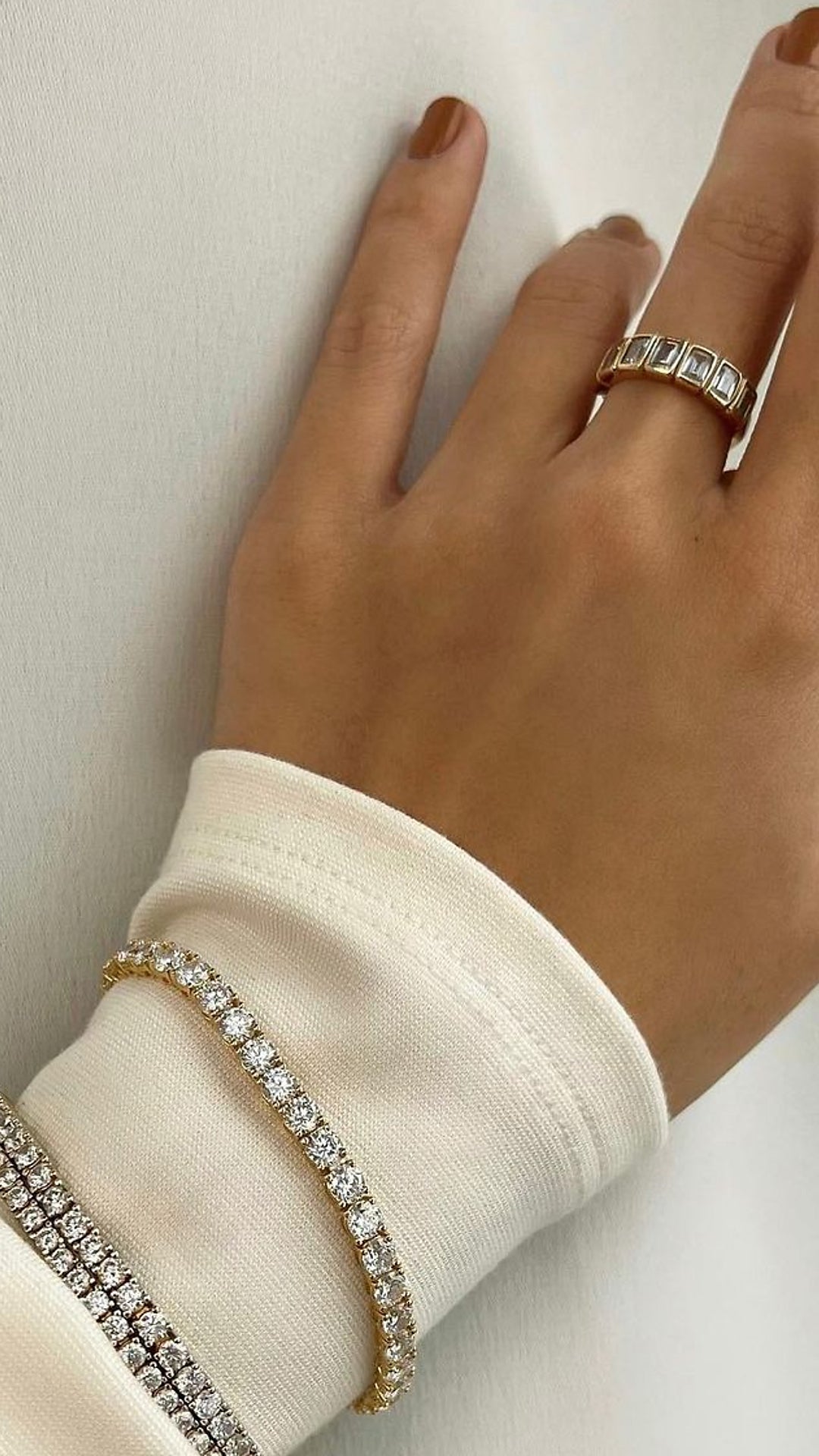 Ladies tennis bracelet stack paired with gold eternity ring.