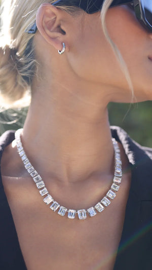 Large diamond look necklace for women paired with simple sterling silver hoops. 