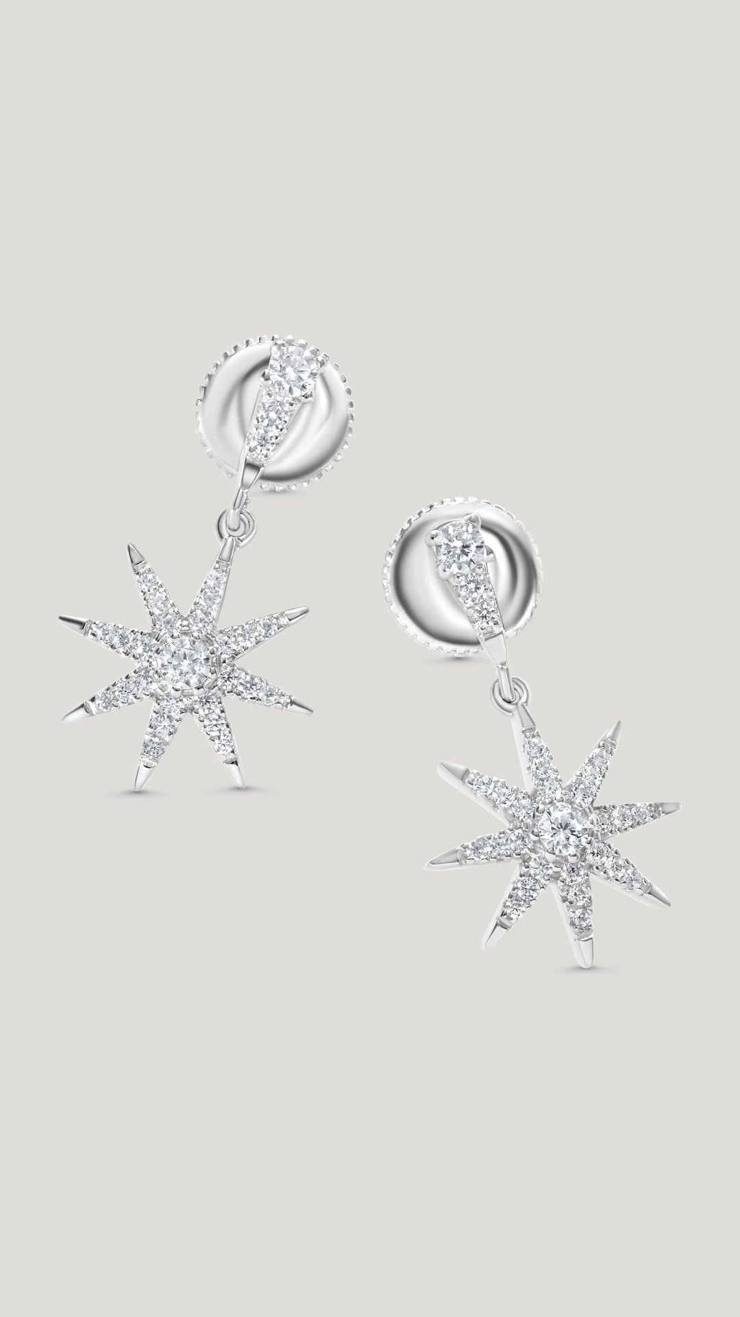 Nysa sterling silver star drop earrings for women.