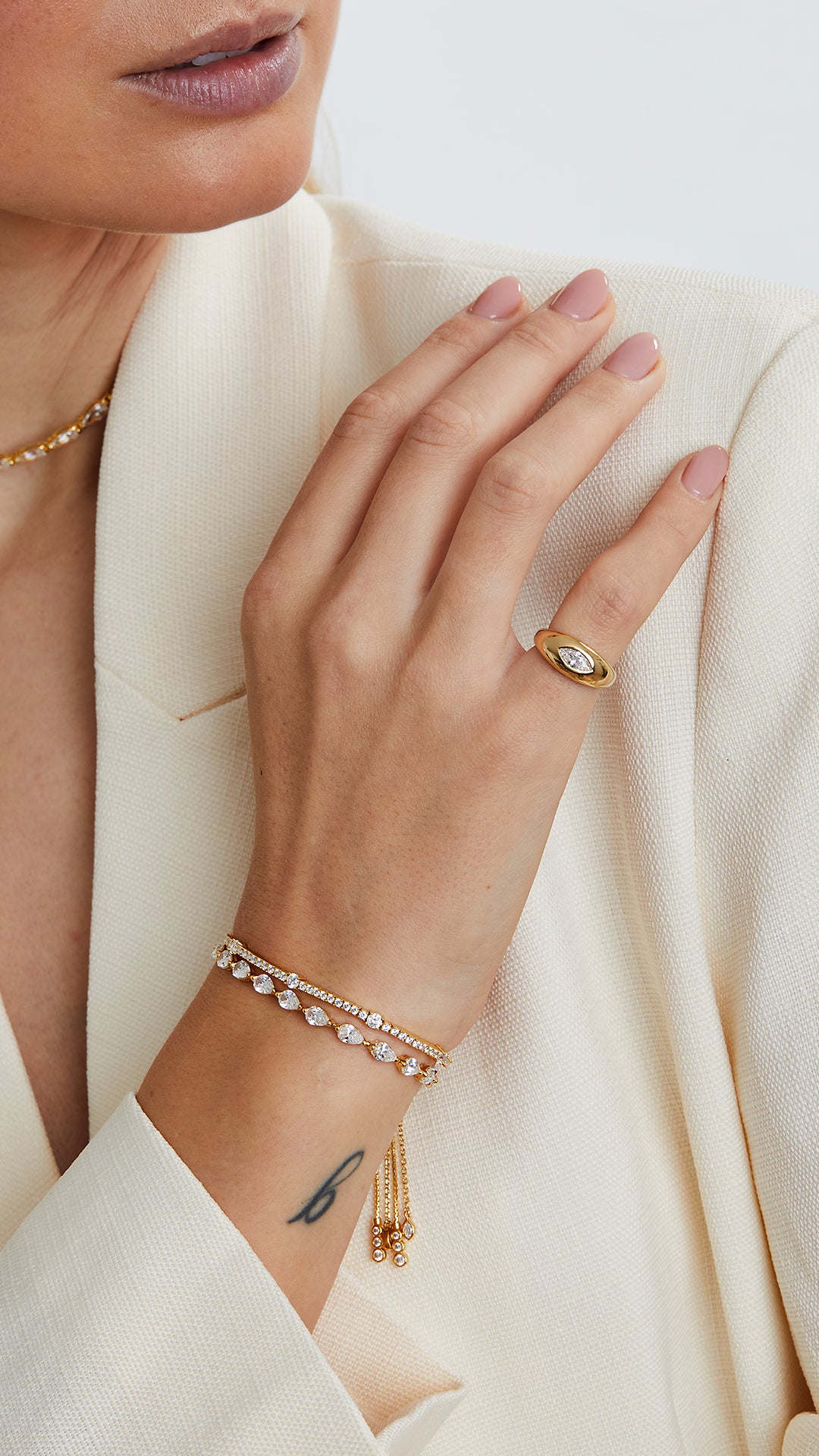 Gold stacking pinky or signet ring, paired here with adjustable and stackable tennis bracelets.