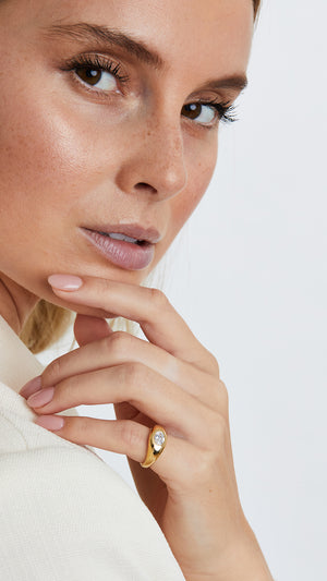 A minimalist gold signet ring with a beautifully cut oval gemstone, crafted in 18K gold vermeil for a refined and elegant look.