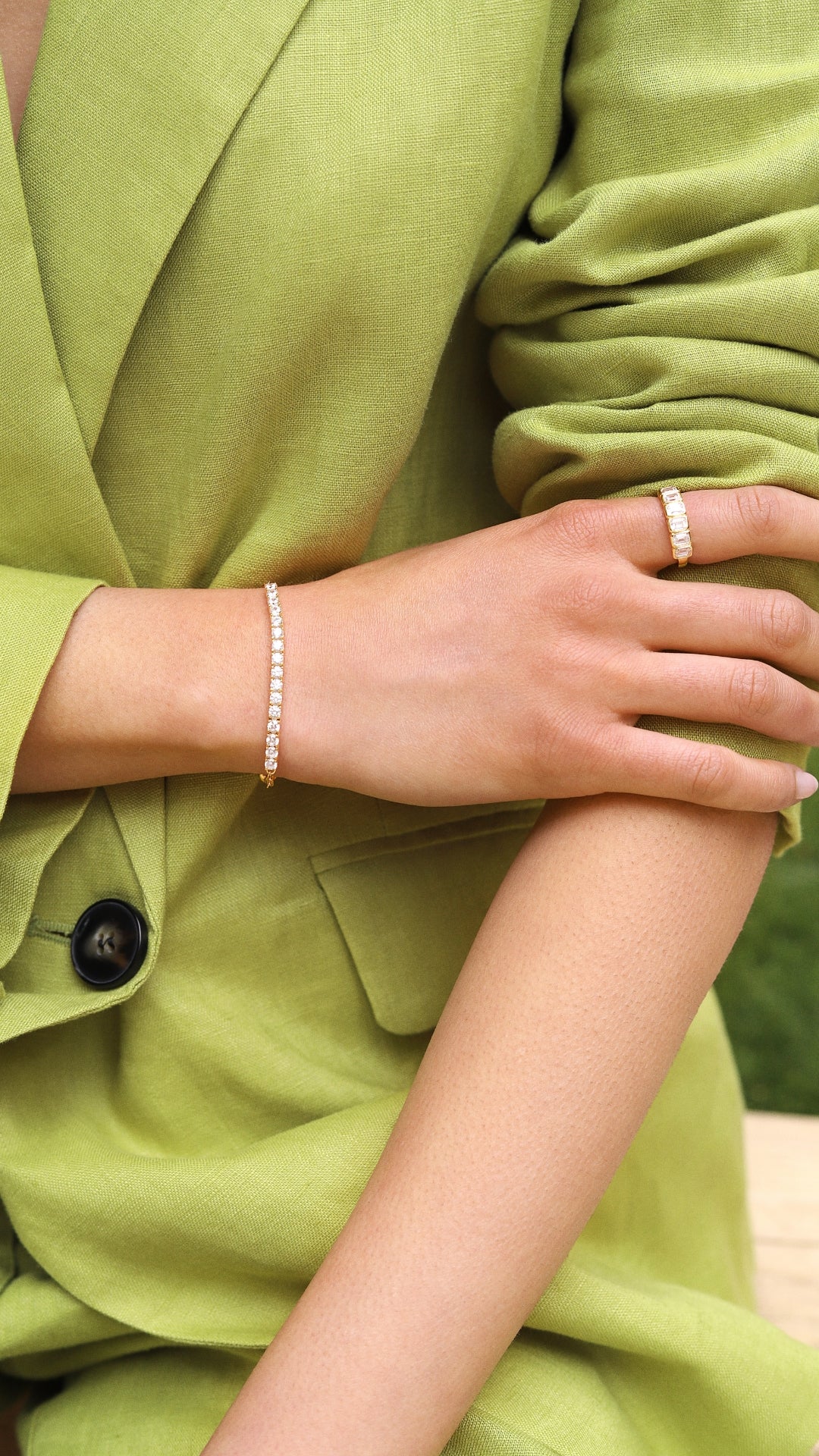 Gold tennis bracelet styled with a Cassidy gold eternity ring for women. 