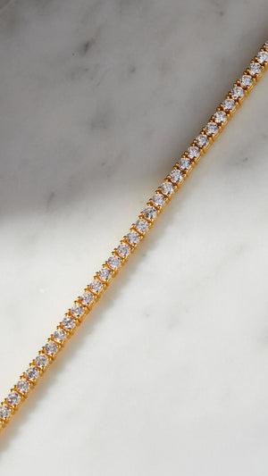 Classic line gold tennis bracelet for women.